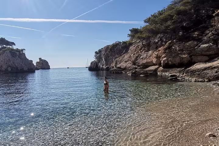 Crystal-clear Calanques bay with pebble beach, ideal swim stop on a Marseille to Calanques hiking tour