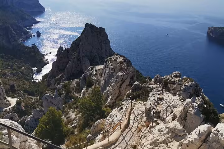 Rocky viewpoint above Calanques cliffs and Mediterranean sea on hiking tour from Marseille, Calanques National Park