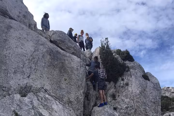 Small group scrambling limestone rocks in the Calanques, guided adventure hike near Marseille and Cassis