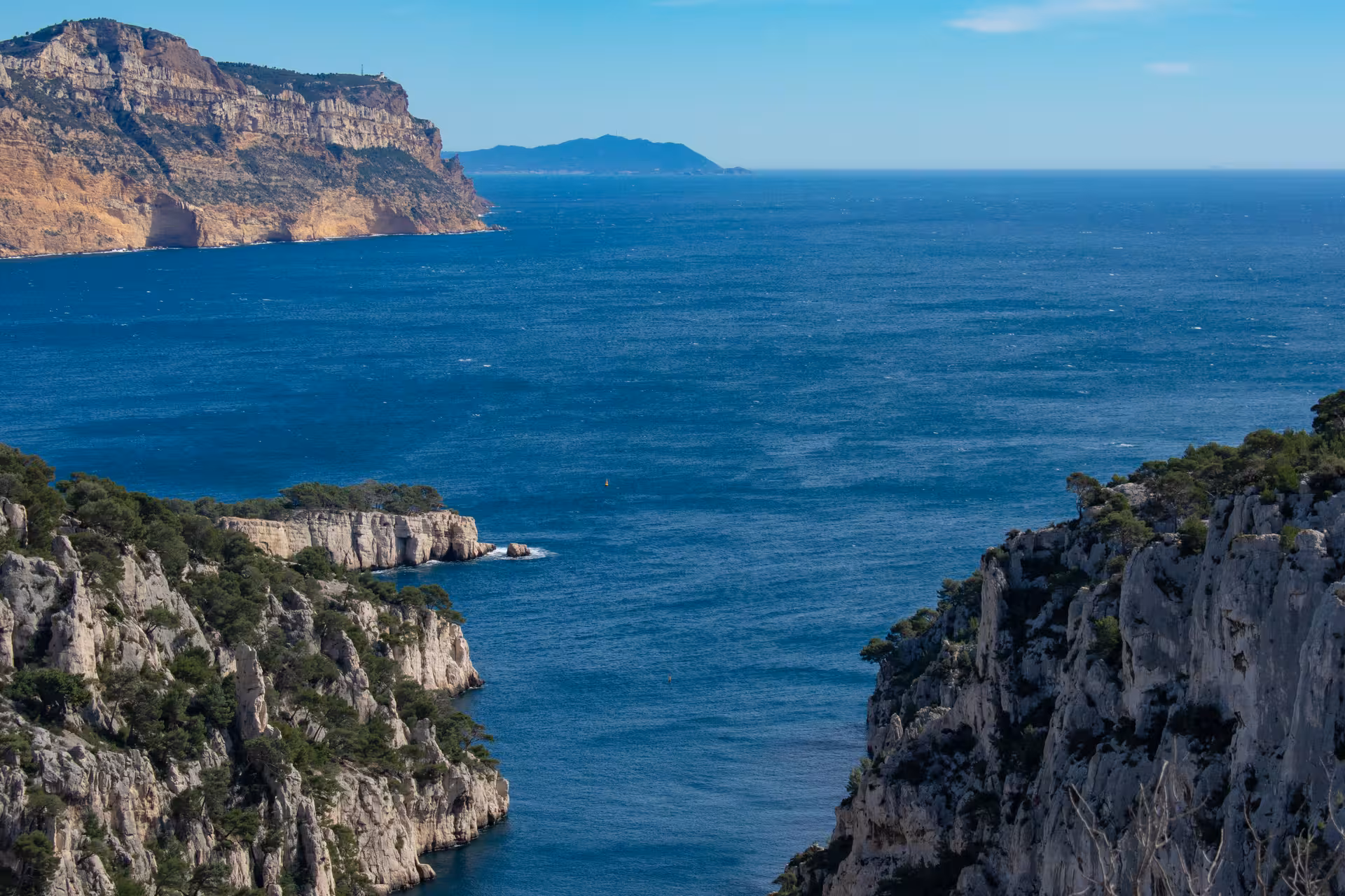 Panoramic view of Calanques cliffs and turquoise Mediterranean from Luminy hike, Marseille national park trek