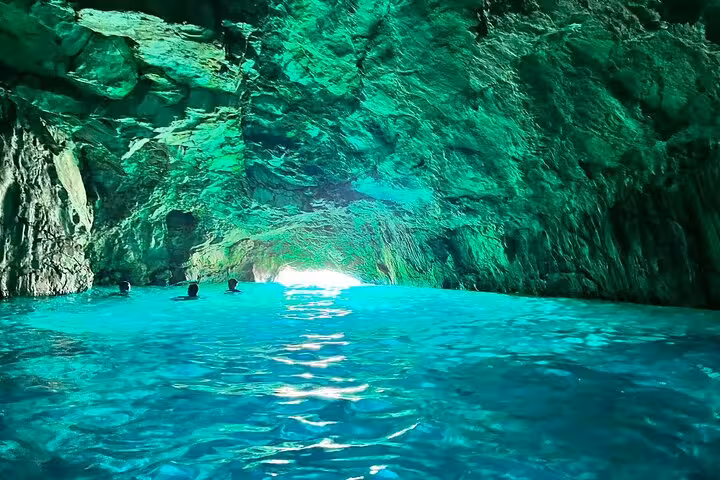 Sea cave with glowing turquoise water in the Calanques near Marseille, a highlight of the hiking tour