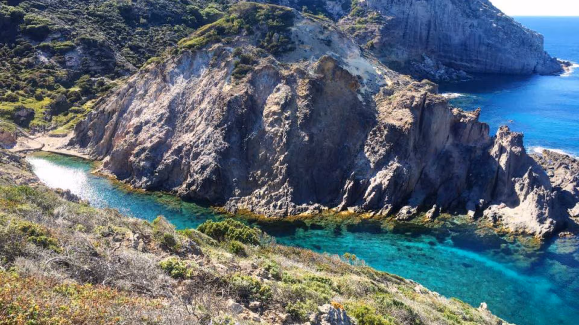 Experience Calasetta's rugged coastline on a scooter, revealing hidden coves and azure seas.