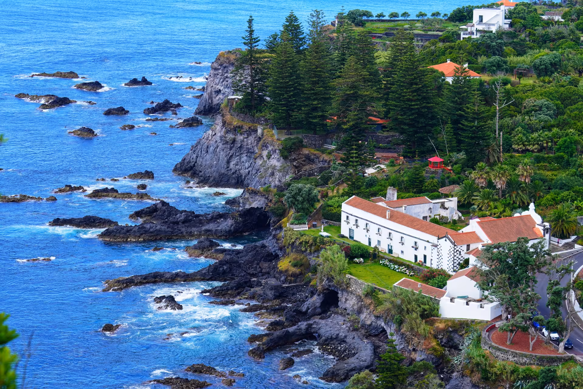 Dramatic Caloura coastline in the Azores with cliffs, Atlantic waves and whitewashed houses above the sea