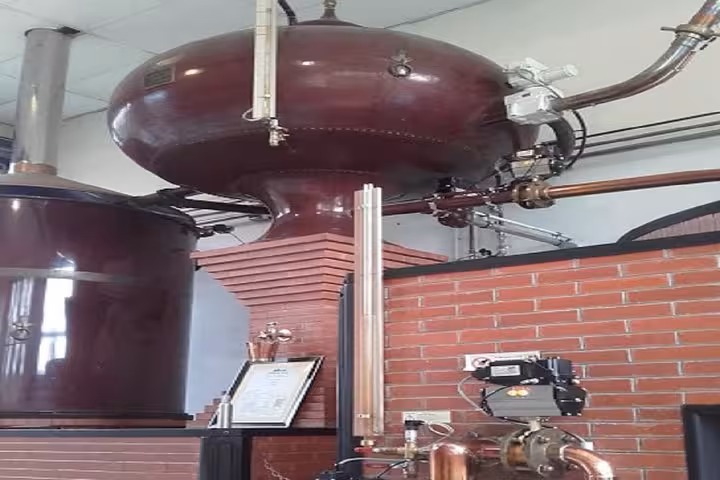 Copper Calvados pot still distillery equipment at a Normandy distillery