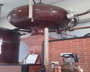 Traditional copper pot still at a Calvados distillery in Pays d'Auge, Normandy day tour from Le Havre