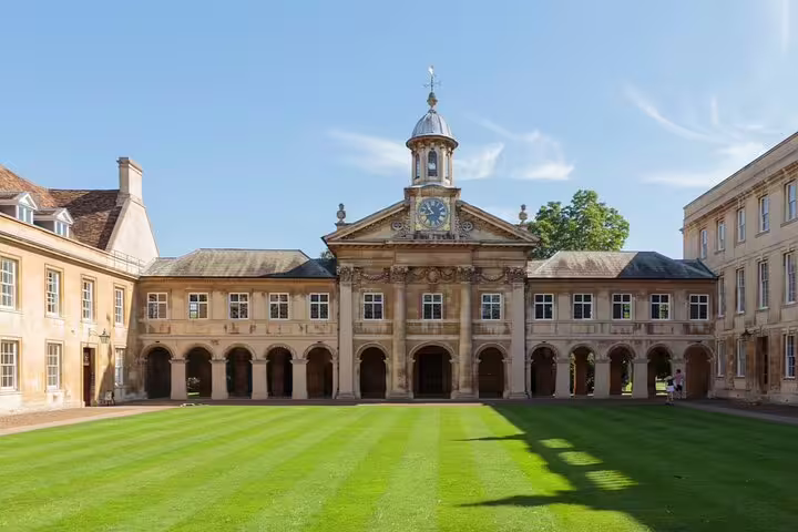 Historic Emmanuel College courtyard with clock tower and arched colonnade, Cambridge University