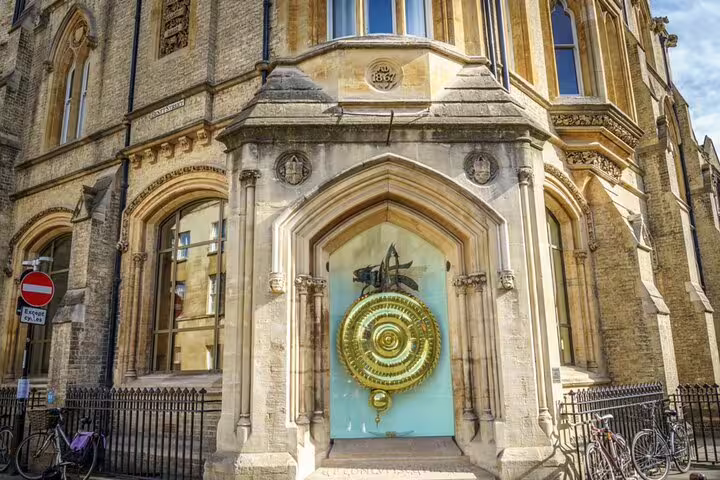 The Corpus Clock with golden grasshopper on Corpus Christi College building in Cambridge
