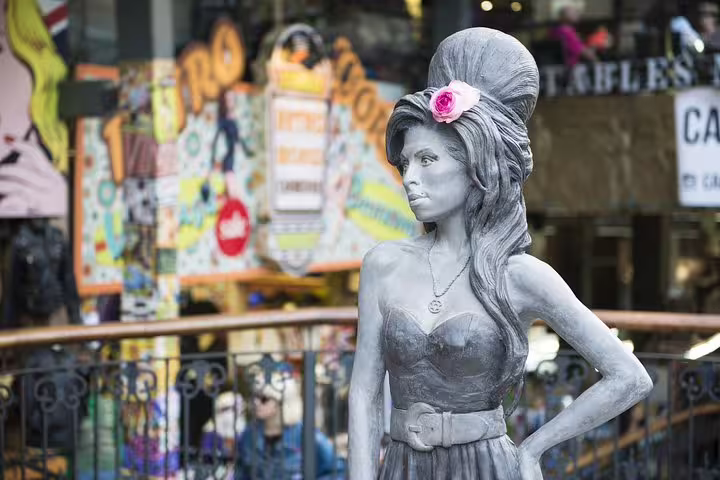 Statue in Camden Market, London, showcasing vibrant street art and bustling atmosphere, highlighting unique tour attractions.