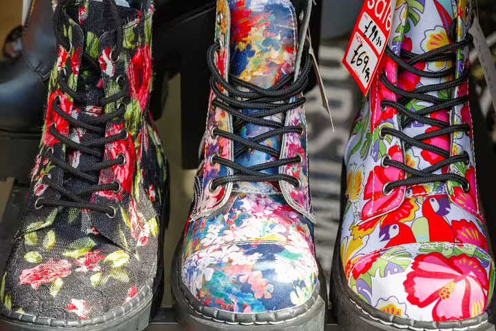 Colorful floral boots on display at a Camden Town market stall, highlighting vibrant street fashion on a London private tour.