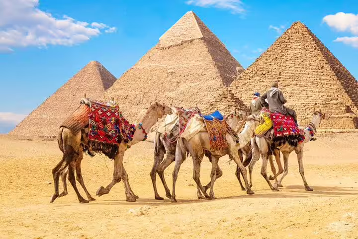 Camel caravan at the Pyramids of Giza, Cairo day tour by bus from Hurghada with desert views