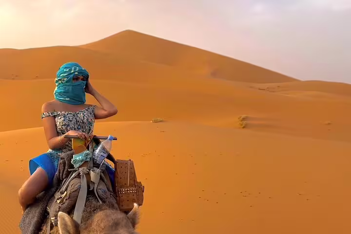 Traveler on camel in Merzouga Erg Chebbi dunes, Sahara Desert highlight on 15-day Morocco tour from Casablanca