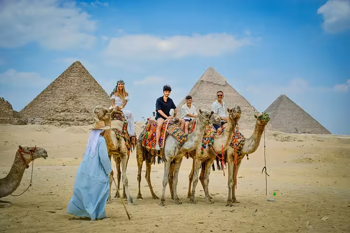 Camel ride at Giza Pyramids during Cairo day trip by plane from Marsa Alam, with desert panorama views