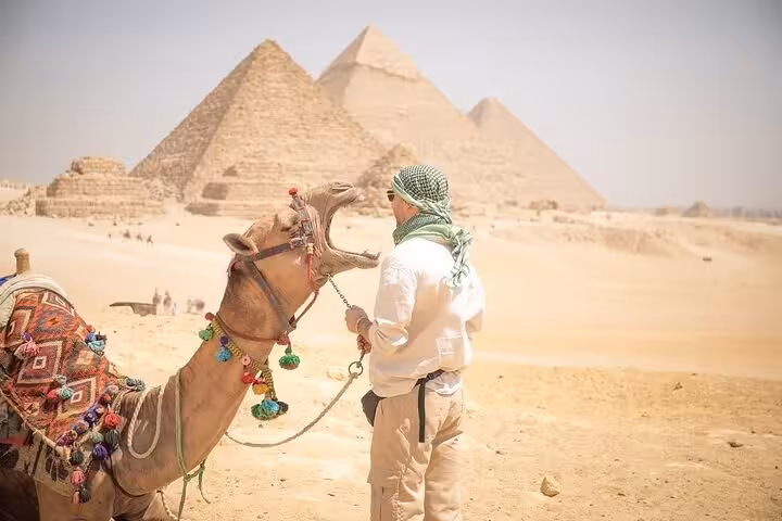 Camel ride view at Giza Pyramids desert on private Cairo tour, iconic photo stop near the Great Pyramids