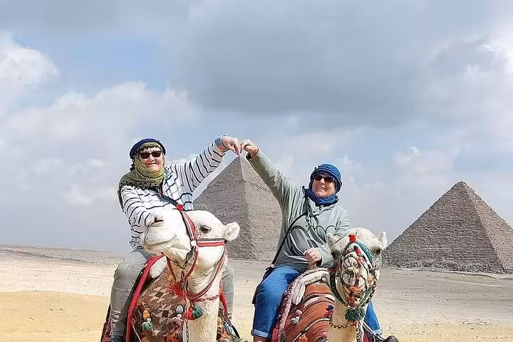 Camel ride photo with Giza Pyramids backdrop on private Sharm El Sheikh to Cairo day tour by domestic flight