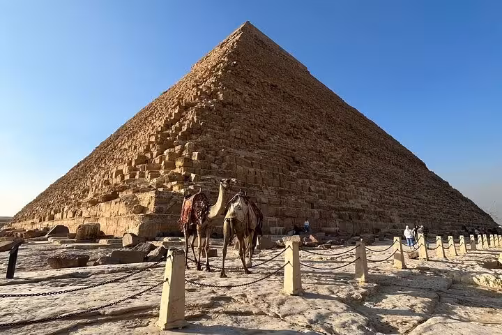 Camel ride beside the Great Pyramid of Khufu at Giza Plateau, part of 3-day Cairo Giza Alexandria private tour
