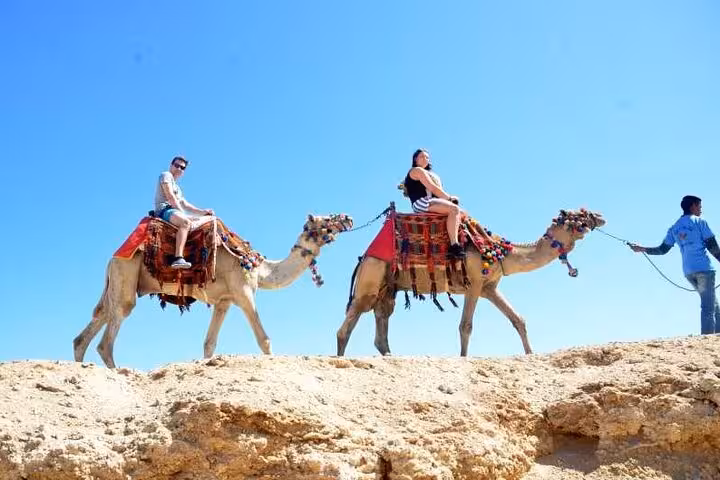 Camel ride in Hurghada desert by the Red Sea, guided safari with decorated camels under bright blue sky