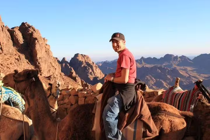 Camel ride at sunrise on Mount Sinai summit, private night tour from Cairo by bus in Sinai desert