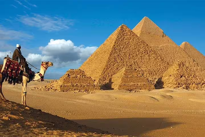 Camel rider beside the Great Pyramid of Giza at golden hour, Cairo photo session add-on tour scenic photo stop