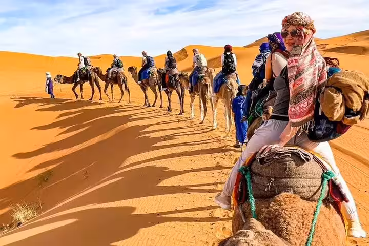 Camel trek in Merzouga Sahara dunes, desert adventure highlight on Morocco 12 days tour from Marrakech