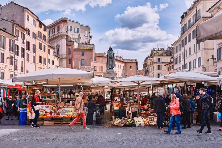 Bustling Campo de' Fiori market in Rome with lively stalls and shoppers, capturing vibrant local culture and historic architecture.