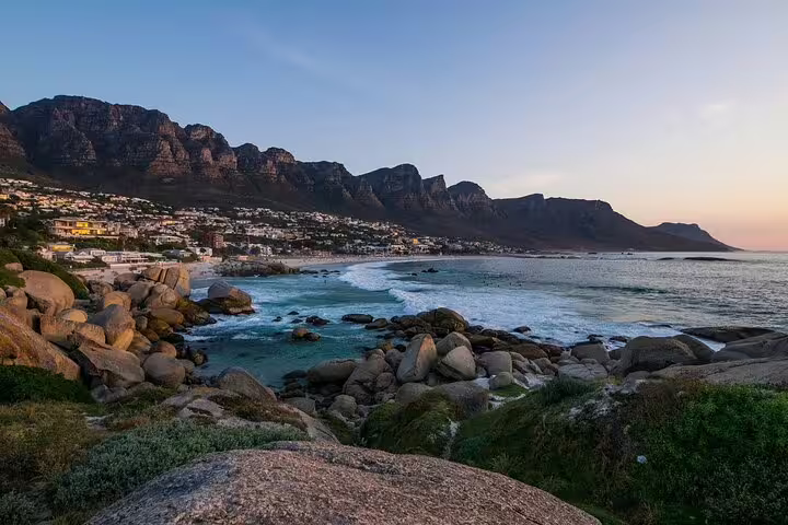 Coastal sunset at Camps Bay with rocky shore and Twelve Apostles, Cape Town half-day sightseeing