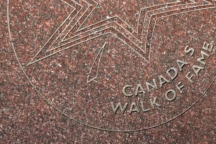 Canada's Walk of Fame engraved granite star emblem on Toronto sidewalk featured in Reel Toronto self-guided walking tour
