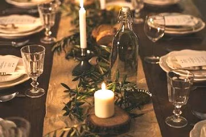 Candlelit farm-to-table dinner setup for a private chef experience in a lavender field with rustic table decor
