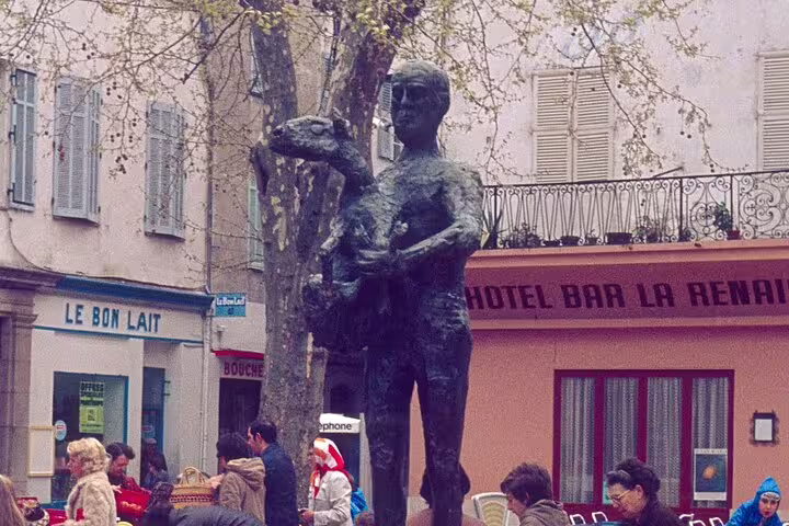 Outdoor art statue in a charming French square, local cafes and culture on the Artistic and Coastal Delights of Cote d’Azur