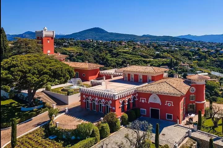 Aerial view of a luxurious estate near Cannes, surrounded by scenic landscapes and gardens.