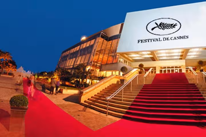 Red carpet stairs leading to Festival de Cannes venue illuminated at dusk on French Riviera