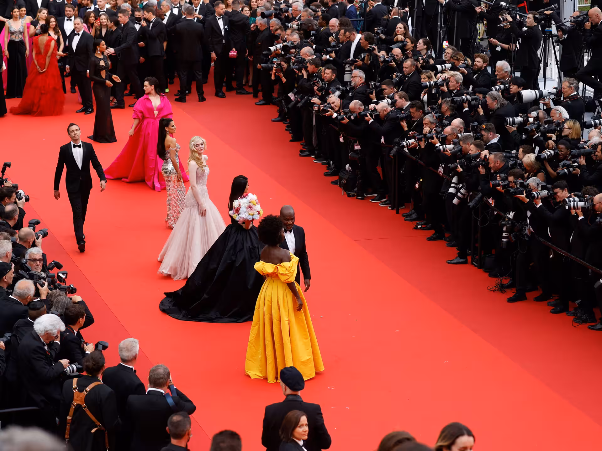 Celebrities walking the red carpet at Cannes Film Festival on the French Riviera with photographers