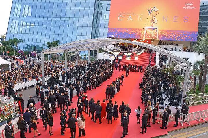 Crowds on the red carpet at the Cannes Film Festival with the iconic Palais des Festivals sign