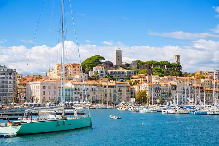 Scenic Cannes harbor with luxury yachts and colorful old town hillside perfect for a private shore tour