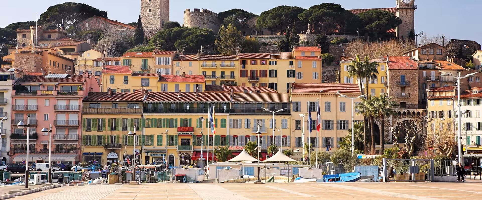 Colorful historic buildings and castle hill of Le Suquet old town in Cannes, French Riviera