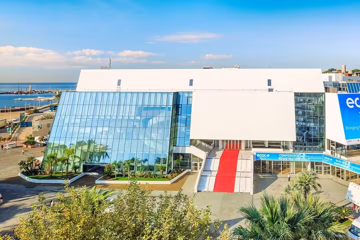 Aerial view of Cannes Palais des Festivals with red carpet entrance and Mediterranean Sea backdrop