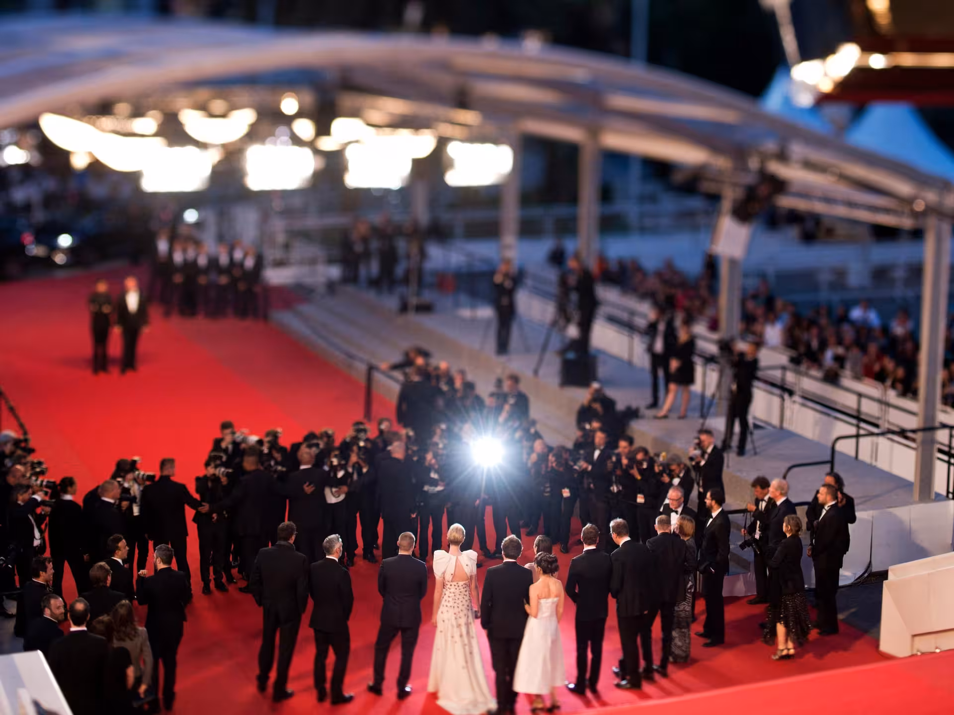 Red carpet event at Cannes with photographers and elegantly dressed attendees on the French Riviera