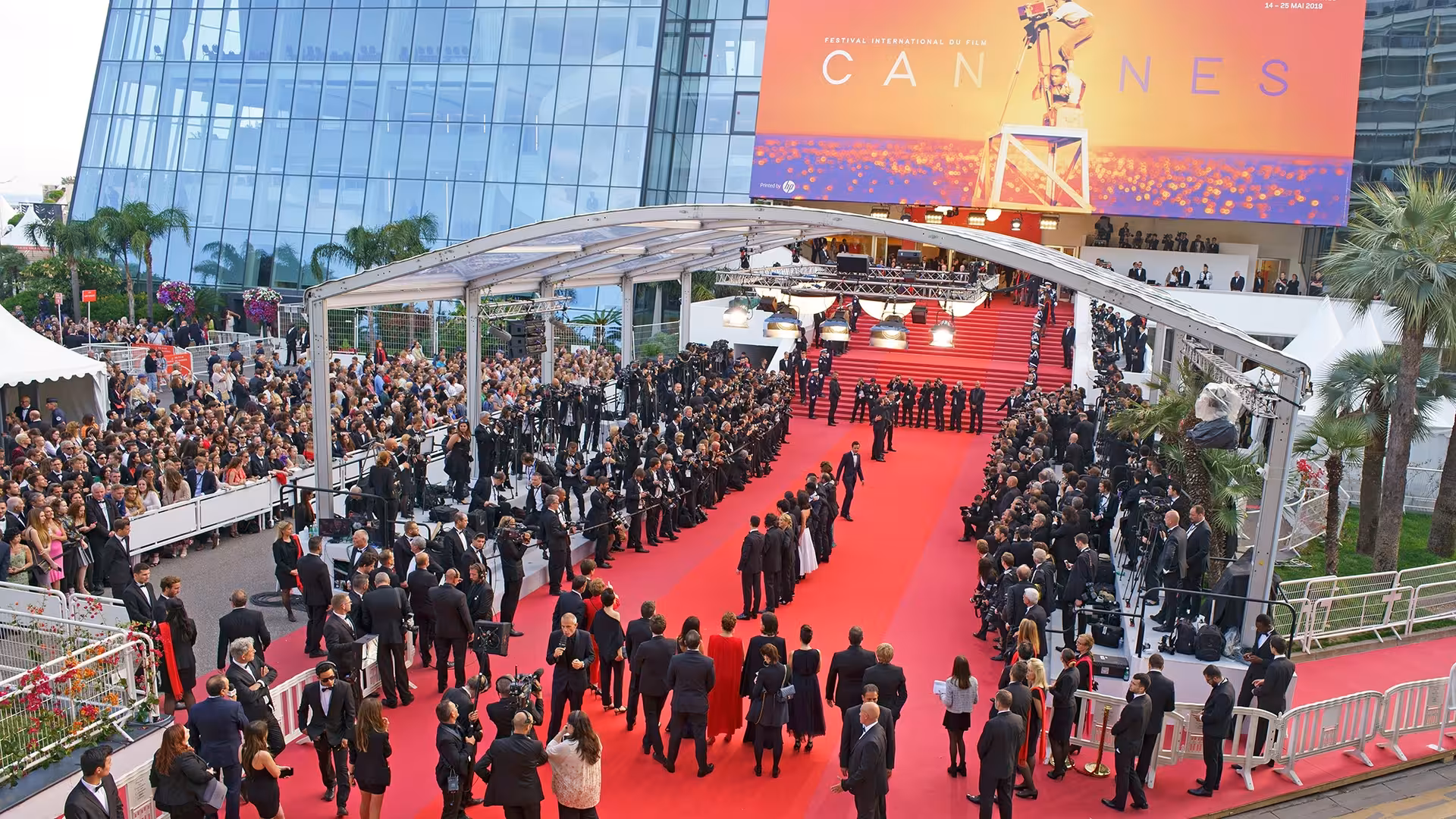 Aerial view of Cannes Film Festival red carpet with crowds and grand staircase at Palais des Festivals