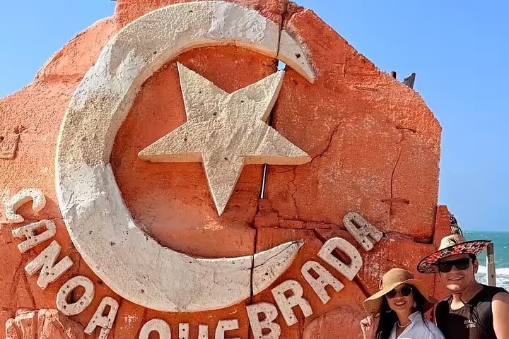 Travelers at the Canoa Quebrada crescent and star landmark on a 3 beaches in 1 day beach tour in Brazil