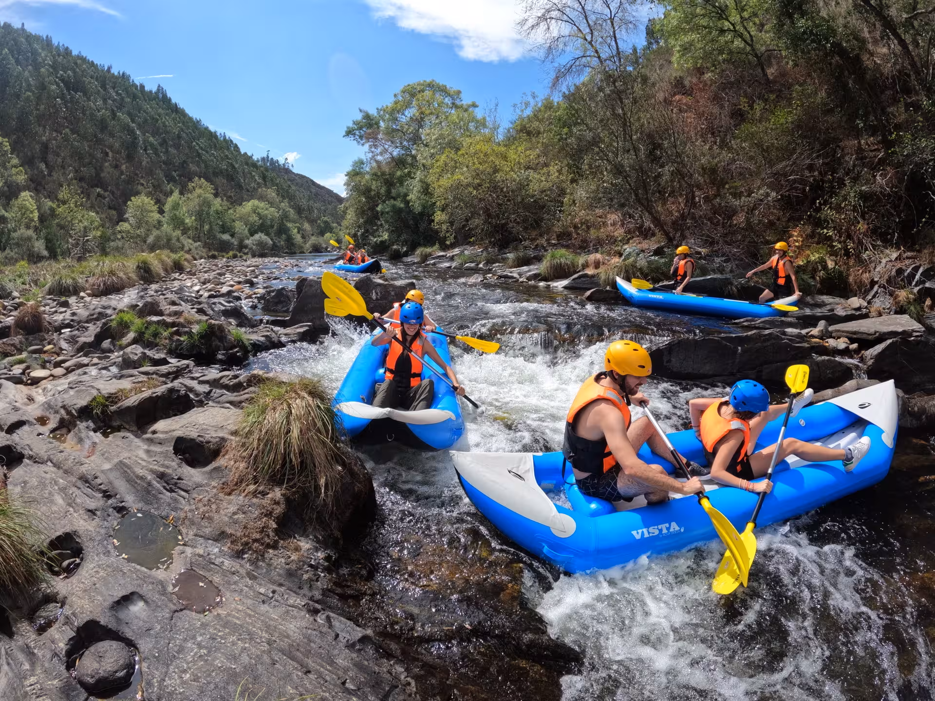 Canoe rafting on Paiva River rapids in Arouca Geopark, Portugal, with helmets and life vests