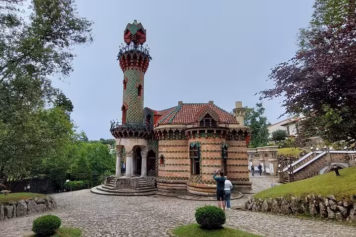 Visitors admire the unique architecture of El Capricho, a must-see on Cantabria's western coastal tour.
