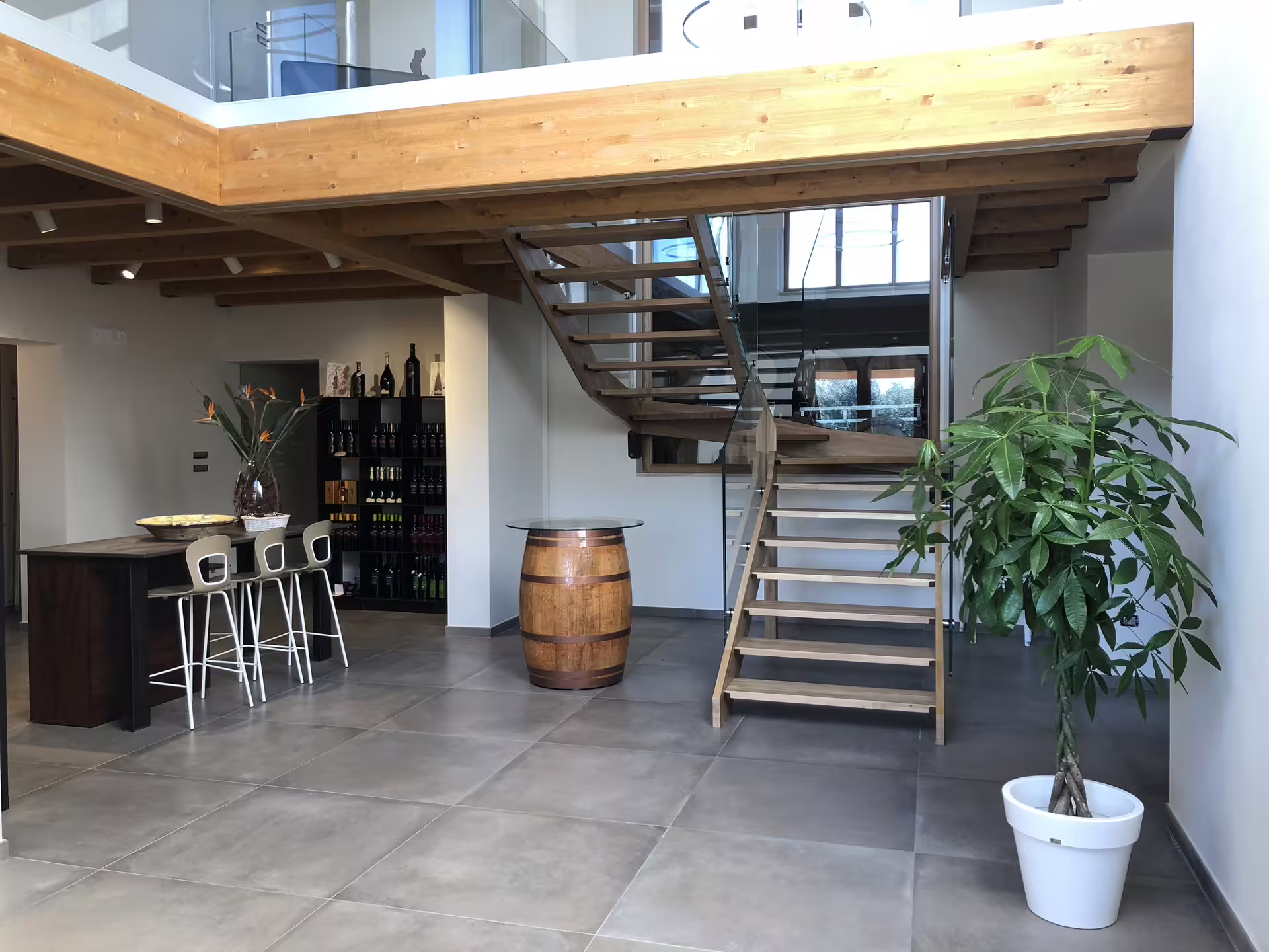 Modern Cantine Mucci winery tasting room with wine bar and barrel table, ideal for wine tasting tour