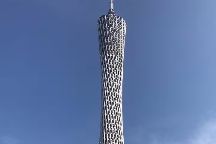 Close-up of Canton Tower against a clear blue sky, showcasing its intricate structure on a sunny day.