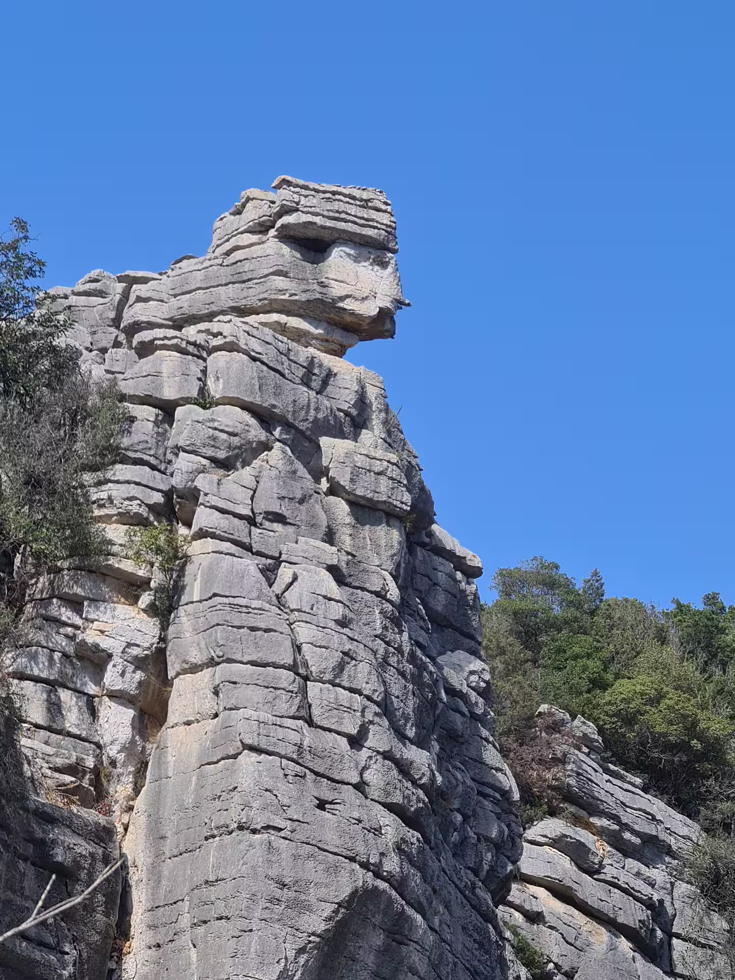 Close-up of a distinctive rock formation against a clear blue sky at Canuto de la Utrera, perfect for hiking enthusiasts.