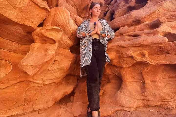 Traveler posing at Canyon Salama rock walls on Sinai Desert jeep safari from Dahab, Egypt