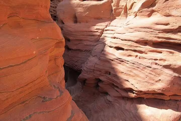 Narrow red sandstone passage in Canyon Salama, Sinai Desert, on Sharm El Sheikh to Dahab jeep safari trip
