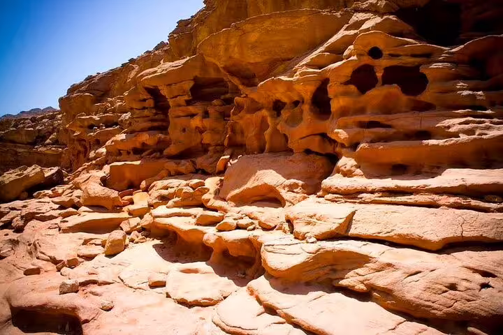 Sunlit sandstone rock formations at Canyon Salama, a jeep safari stop on the Sharm el Sheikh to Dahab tour