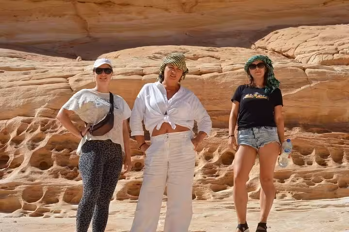 Tourists in keffiyeh scarves at Canyon Salama during Sinai Desert jeep safari and Dahab snorkeling
