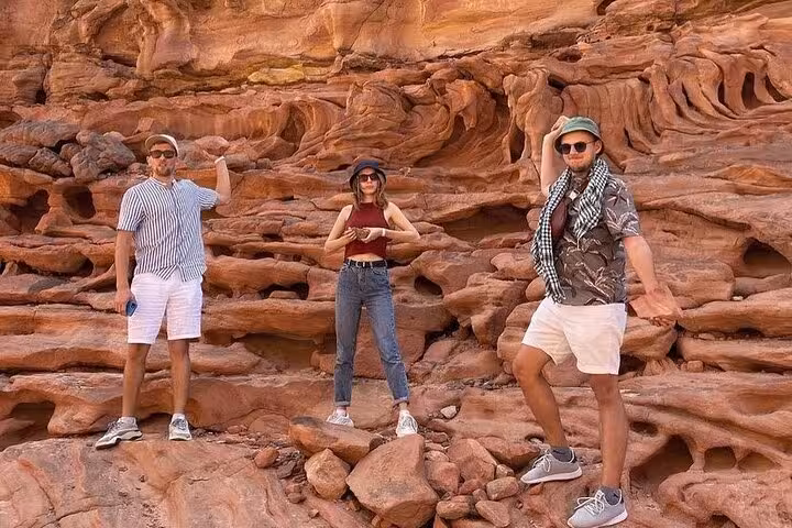 Group photo at Canyon Salama sandstone formations on Sinai Desert jeep safari with Dahab snorkeling stop
