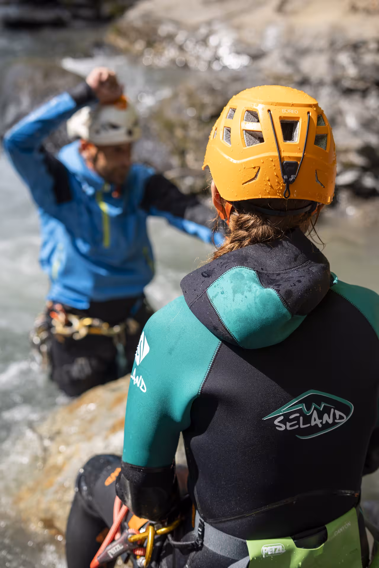 Canyoning enthusiasts in protective gear prepare for adventure in Interlaken's scenic waterways and rocky terrains.