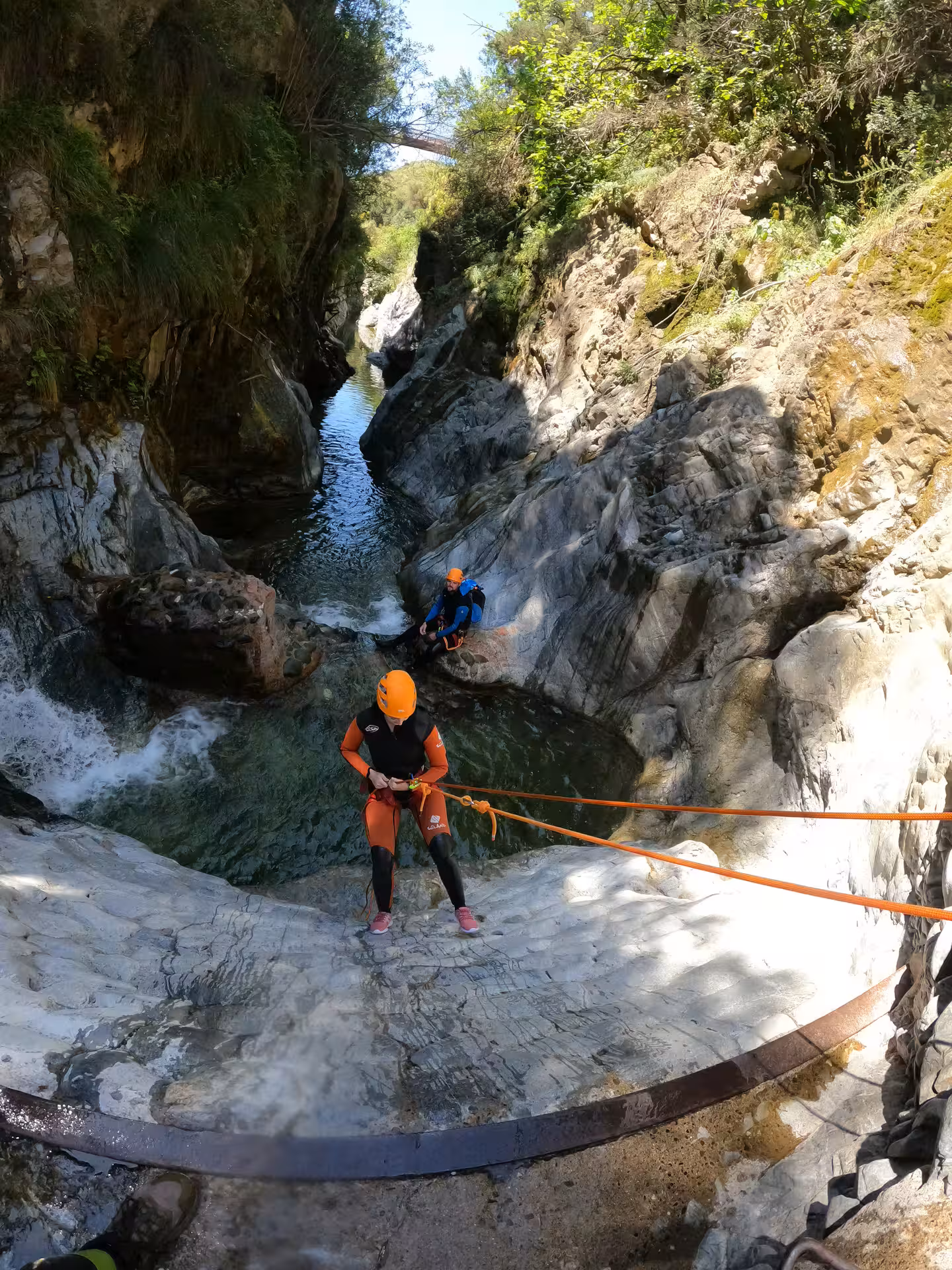 Two adventure participants rappel rocky cliffs during a guided canyoning tour in Guadalmina Canyon Estepona